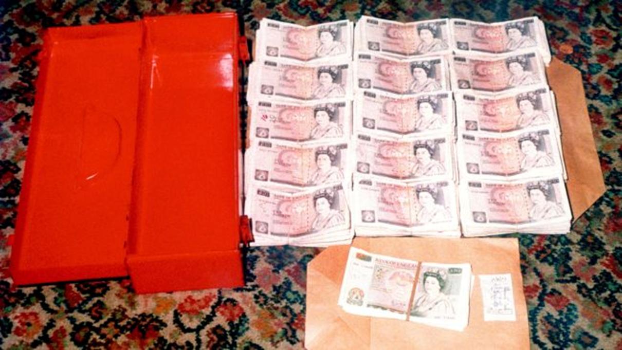 Piles of notes and container pictured.Some of the ransom money recovered by police investigating the kidnap of Stephanie Slater